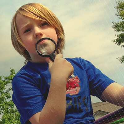 kid with magnifying glass