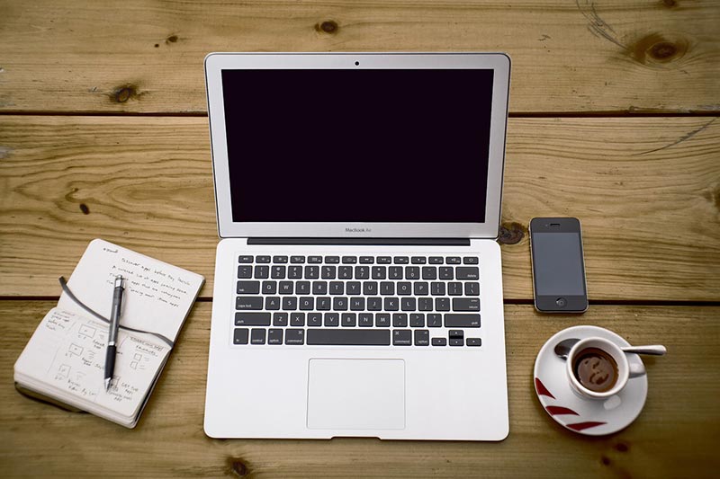 office desk with computer and writing materials